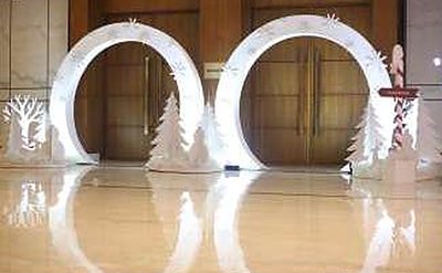 Pair of white winter arch installations flanking the ballroom entrance