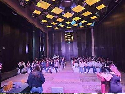 Workshop-format seating and a speaker addressing the room at the EY offsite