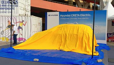 Hyundai Creta Electric under a gold reveal cover before unveiling