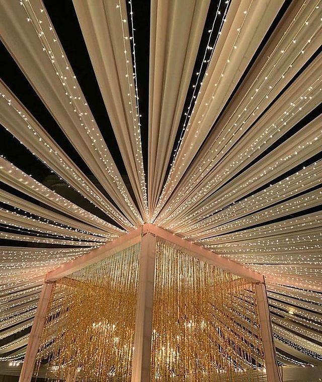 Starburst canopy of fairy lights radiating from a central mandap structure